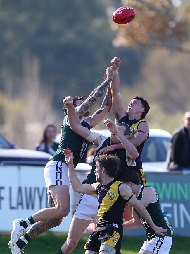 Echuca ruckman Kane Morris is surrounded by teammates and Rochester opponents.