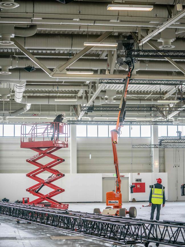 Workers prepare a fairground for a makeshift hospital, called Corona treatment center Jaffestrasse, in Berlin. Picture: Michael Kappeler