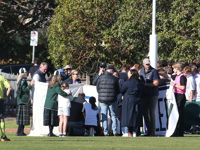 Officials, parents and students converge around Patrick Shirlow. Picture: Alan Barber