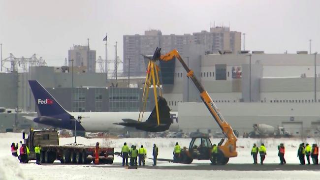 A crane lifts the debris of the plane at Toronto Pearson Airport. Picture: CTV