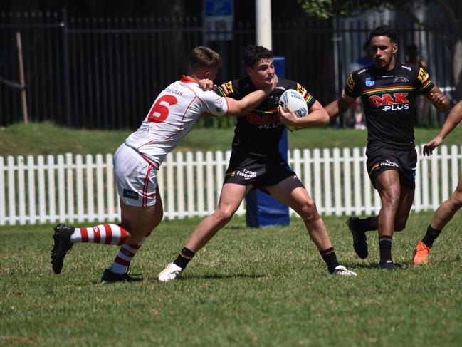 Riley Pollard is tackled by Jonty Perestrelo in the SG Ball Cup. Picture: Sean Teuma/NewsLocal