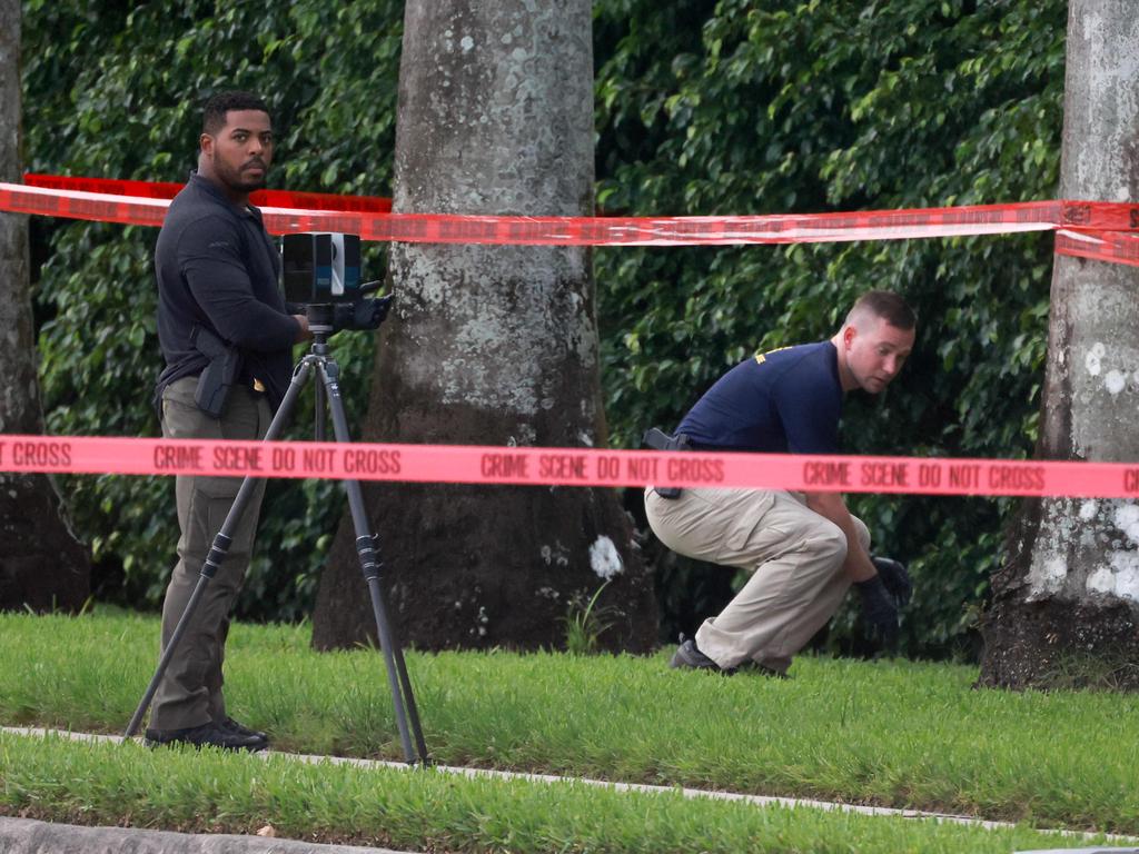 Law enforcement personnel investigate the area around Trump International Golf Club after the apparent assassination attempt of former President Donald Trump on September 15 local time. Picture: Joe Raedle/Getty Images North America/Getty Images via AFP