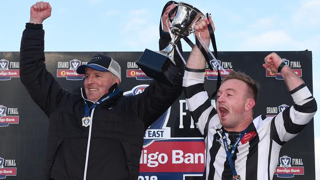 Narre Warren coach Matt Shinners and captain Dylan Quirk hold aloft the premiership cup. Picture: Josie Hayden