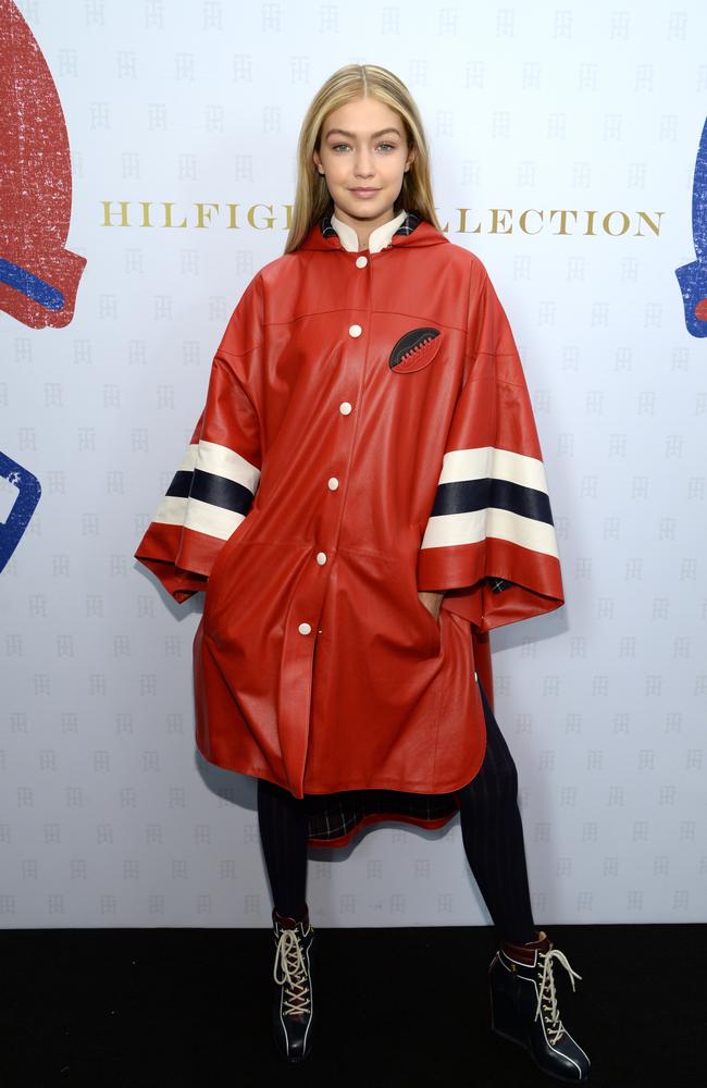 Gigi Hadid in the red and white poncho backstage at Tommy Hilfiger Fall 2015 runway show. Picture: Kevin Mazur/Getty Images for tommy Hilfiger.