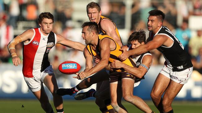 Luke Hodge fires off a handball against St Kilda.