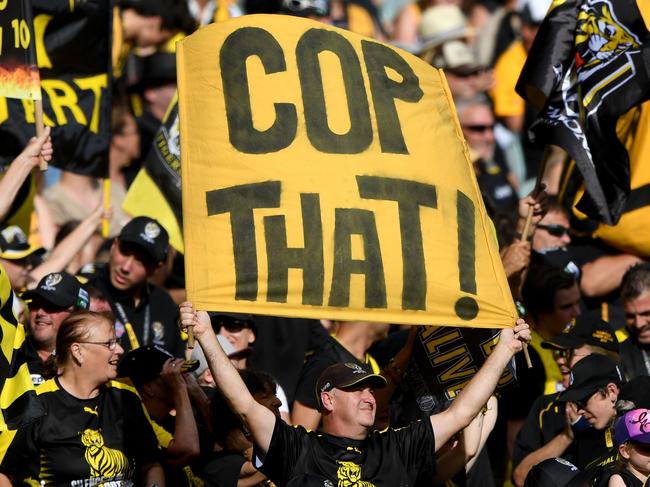 Tiger fans celebrate a goal during the Round 3 AFL match between the Richmond Tigers and the Hawthorn Hawks at the MCG in Melbourne, Sunday, April 8, 2018. (AAP Image/Joe Castro) NO ARCHIVING, EDITORIAL USE ONLY