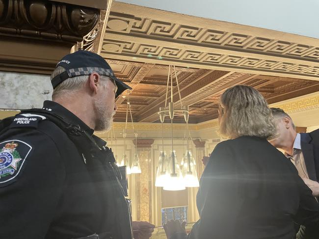 A policeman escorts a protester from the Chamber.