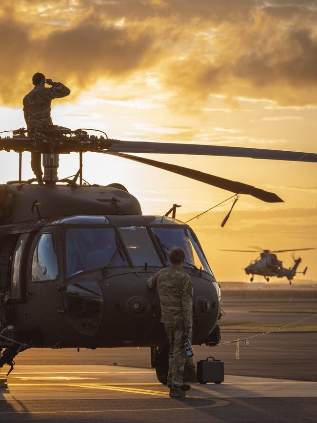 Talisman Sabre 2023., United States Army aircrew watch an Australian Army ARH Tiger Attack helicopter land from their UH-60M Blackhawk helicopter during Exercise Talisman Sabre 2023 at RAAF Base Townsville.