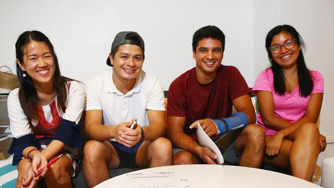 Plans to fly international students to Cairns are stymied by border closures. Fang Srisantisuk of Thailand, Cristian Guerrero of Colombia, Diemes Alves Pereira of Brazil and Elizabeth Martinez from Peru prepare for an English test at the Study Cairns student hub in Lake Street. PICTURE: BRENDAN RADKE