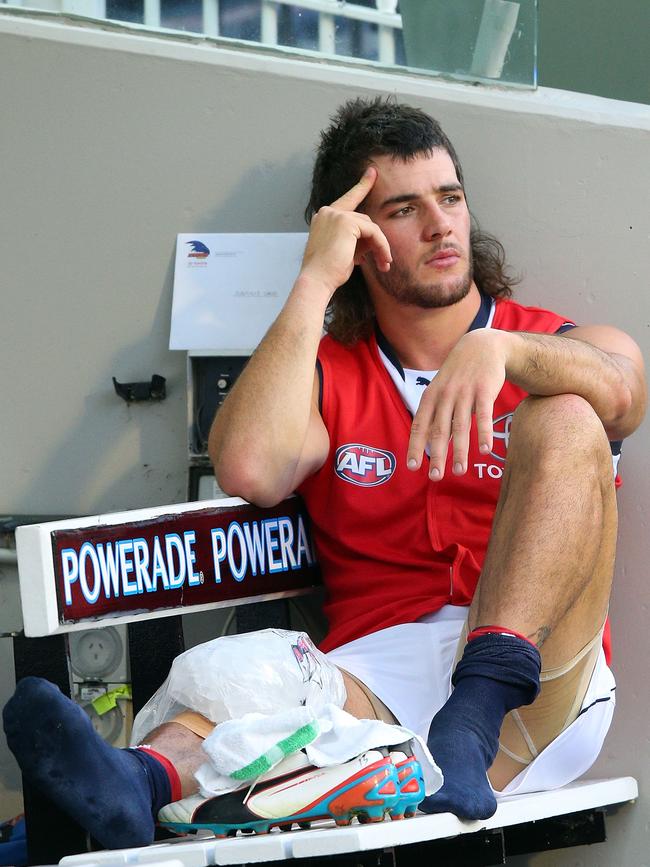 Walker sits on the bench after injuring his leg during the round 5 AFL match between the Carlton and the Crows at the MCG in 2013. Picture: Michael Dodge/Getty Images.