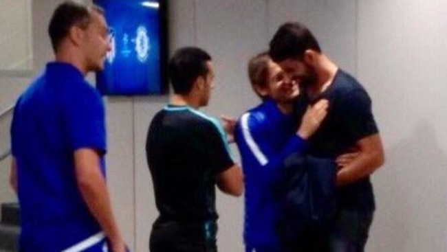 Diego Costa (L) and Antonio Conte's brother, Gianluca, embracing.
