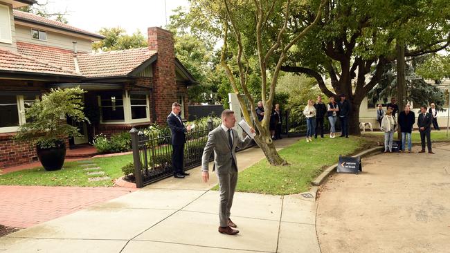 Auctioneer David Cortous calls bids at the Vincent Ave auction in Geelong. Picture: David Smith