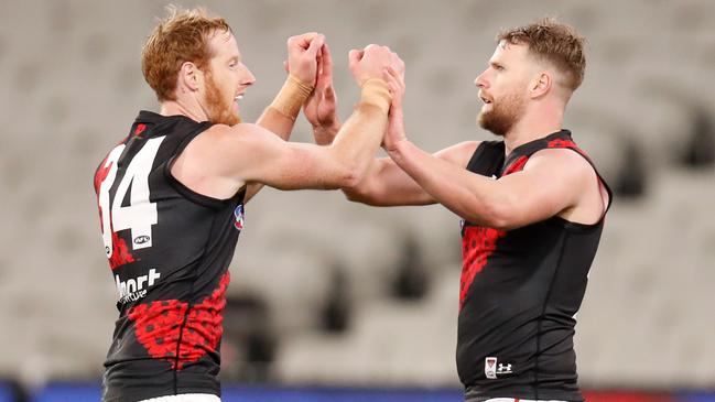 Andrew Phillips (left) and Jake Stringer celebrate an Essendon major.