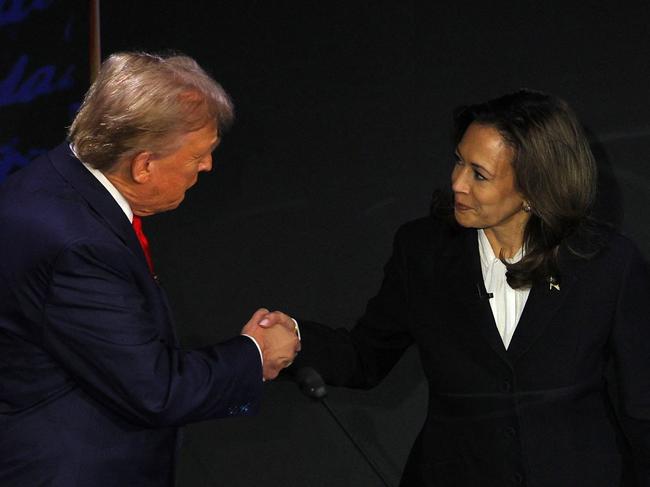 Republican presidential nominee, former U.S. President Donald Trump and Democratic presidential nominee, U.S. Vice President Kamala Harris shake hands as they arrive at their podiums to attend a presidential debate hosted by ABC in Philadelphia, Pennsylvania, U.S., September 10, 2024. REUTERS/Brian Snyder     TPX IMAGES OF THE DAY