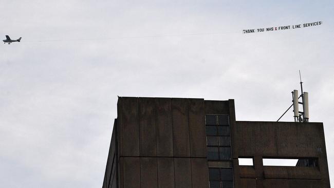 A plane flies over the Royal Liverpool Hospital towing a message of support for workers of Britain's National Health Service. Picture: AFP