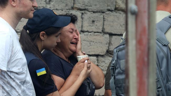 The mother of an employee who was killed after a missile strike on an administrative building in the centre of Odessa. Picture: AFP