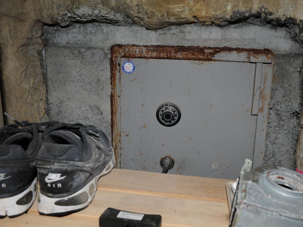 One of three safes located by police, this one in a bedroom contained more than $20,000 cash and an iPhone.