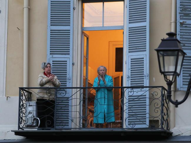 Women take part in a daily 8 o'clock applause in support of medical workers in the French Riviera city of Nice, southern France. Picture: AFP