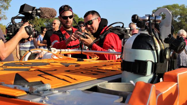 Luke Purdy and Taylor Smith check over their diving equipment before heading off. Picture: Jason Walls