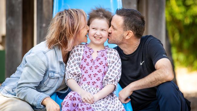 Imogen Mulgrew, 9, with parents Shannon and Luke. Picture: Mark Stewart