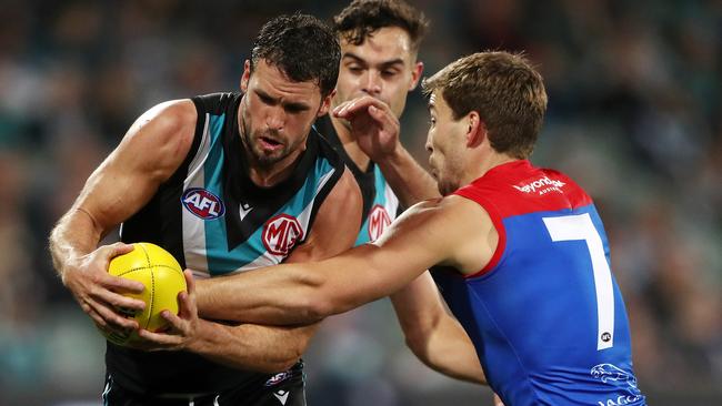 Travis Boak is tackled by Melbourne midfield counterpart Jack Viney. Picture: AFL Photos via Getty Images