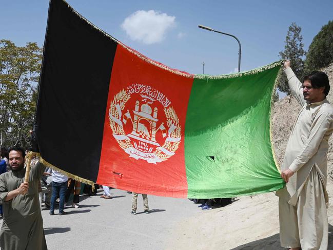 Afghans celebrate the 102nd Independence Day of Afghanistan with the national flag in Kabul on Thursday. Picture: Wakil Kohsar/AFP