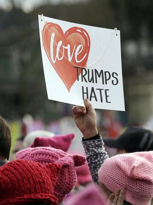 A sign is held aloft at the rally in Seattle. Picture: AP Photo/Elaine Thompson