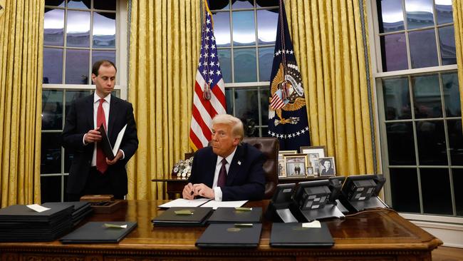 Trump signs executive orders in the Oval Office on Tuesday. Picture: Getty Images via AFP