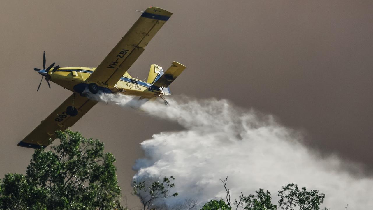 Water bombers battle dangerous fire conditions as a bushfire rolls through the Litchfield/Batchelor area in late August. Picture: Glenn Campbell