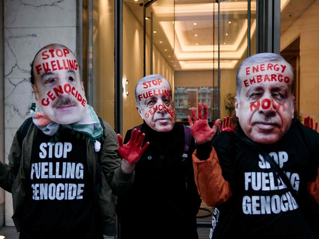 Protesters wear masks as they gather for a combined March for Global Climate Justice, organized by the Cimate Justice Coalition, in London on November 16, 2024, 