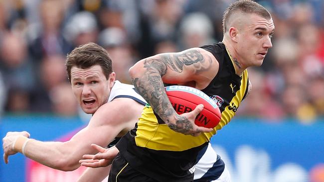 Dustin Martin evades the tackle of Patrick Dangerfield.