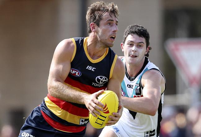 Adelaide’s Richard Douglas evades Power’s Darcy Byrne-Jones at Port Pirie’s Memorial Oval. Picture SARAH REED