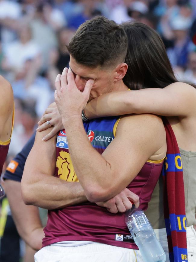 Dayne Zorko is comforted by partner Talia De Marco. Picture Lachie Millard