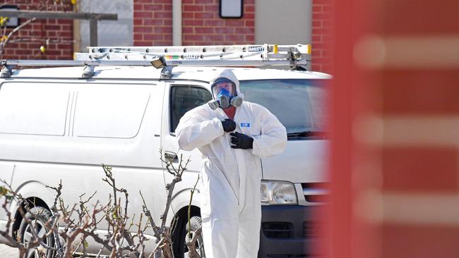 Cleaners at Thebarton Senior College after a person who tested positive for COVID-19 attended the school while possibly infectious. Picture: Tom Huntley