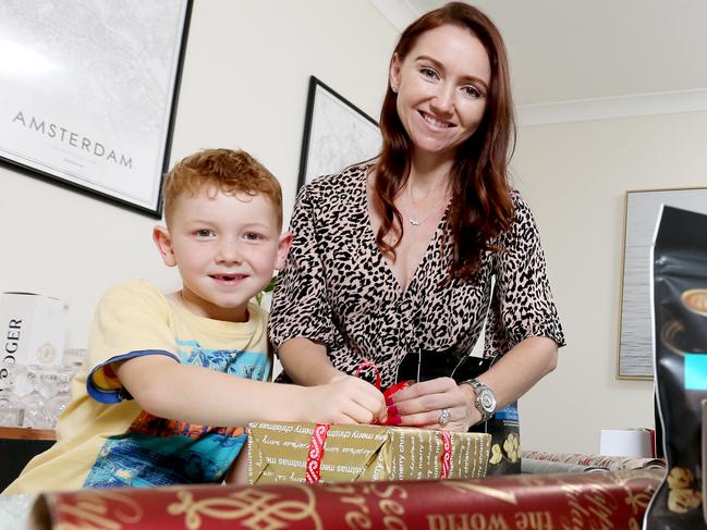 Elisha Olsen with her kids, L to R, Saxon 6yrs & Xavier 8yrs, wrapping Christmas gifts, ready for the festive season, Eatons Hill, on Friday 18th October 2019 - Photo AAP/image Steve Pohlner