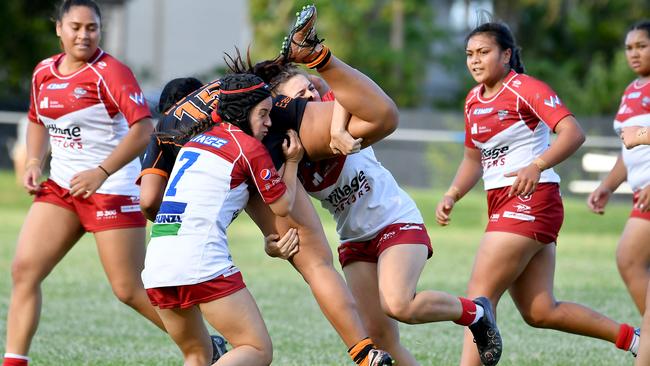 Brisbane Tigers player Estanoa Faitala get taken off the ground by Redcliffe players. Picture, John Gass