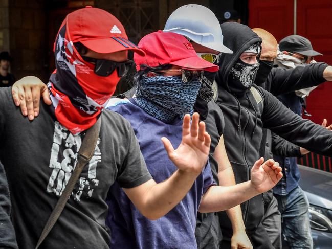 Campaign Against Racism & Facism and No Room for Racism supporters counter protest a Donald Trump victory celebration organised by far right wing groups the United Patriots Front and the True Blue Crew at State Parliament in Melbourne. Masked Anti Facist Antifa members march through the CBD. Picture: Jake Nowakowski