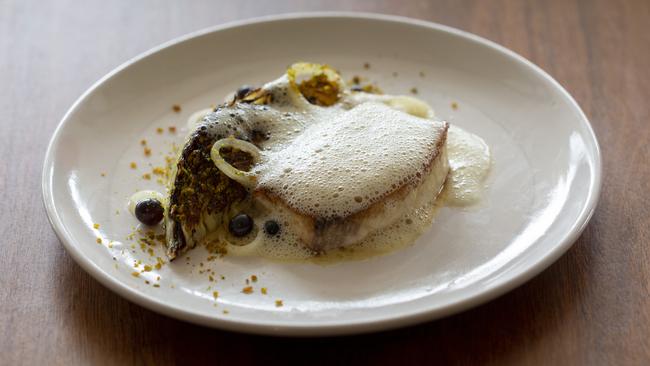 Perfectly cooked fish beneath a froth of yuzu kosho (a Japanese condiment combining chillies and yuzu citrus fruit zest) butter. Picture: Russell Shakespeare