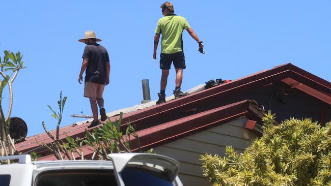 Gold Coast residents clean up following heavy thunderstorms in late December. Picture: NCA NewsWire / Scott Powick