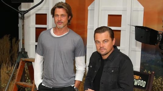 Leonardo DiCaprio wearing Outland denim jeans and jacket while promoting a film with Brad Pitt.
