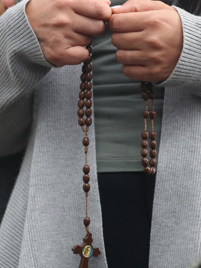 A mother prays for her children. Picture: John Grainger