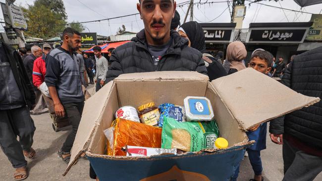 A man with a cardboard box of food aid provided by non-profit non-governmental organisation World Central Kitchen in the southern Gaza city of Rafah on Sunday. Picture: AFP