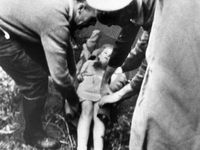 Wendy Pfeiffer (now Sheppard), 9, of Mylor, being tended by police and volunteers as she lay on the ground on a blanket soon after being found on October 25, 1966. Picture: The Advertiser