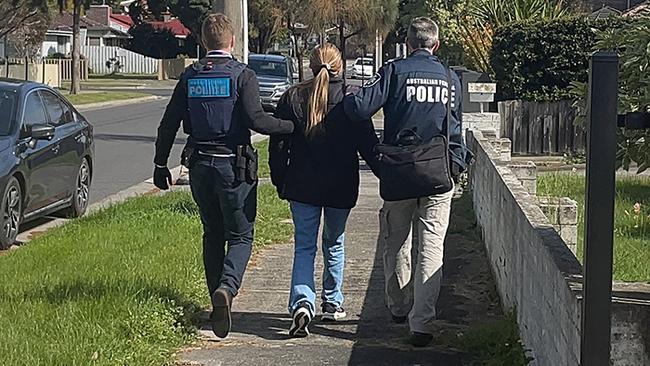 One of the women arrested by AFP officers after the raids.