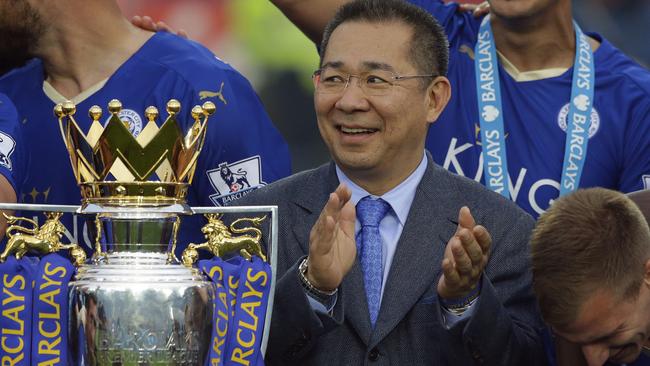 FIEL - In this May 7, 2016, file photo, Vichai Srivaddhanaprabha applauds beside the trophy as Leicester City celebrate becoming the English Premier League soccer champions at King Power stadium in Leicester, England. Thai billionaire and Leicester City owner Srivaddhanaprabha, who died when his helicopter crashed in a parking lot next to the soccer club's stadium, was known to fans as a smiling, benevolent man who gave away free beers and hot dogs on his birthday and brought the club its fairytale English Premier League title in 2016. He was 60. (AP Photo/Matt Dunham, File)