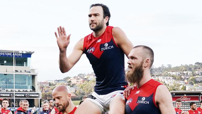 Jordan Lewis is chaired off by Nathan Jones and Max Gawn after his last AFL game. Picture: Michael Dodge/AAP.