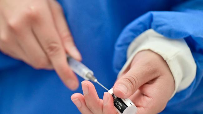 A health worker prepares a dose of the Pfizer vaccine against Covid-19. Picture: Pedro Pardo / AFP