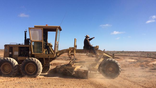 Phil Turner recreating the image with a grader. Picture: Greg Dunstan