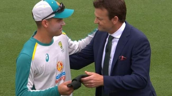 Wicketkeeper Alex Carey receives his baggy green from Adam Gilchrist