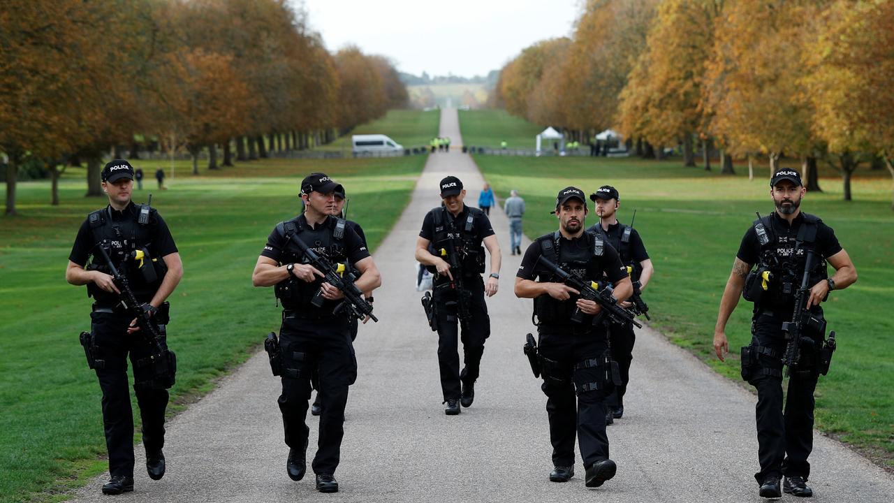 Armed police officers walk down the Long Walk towards Windsor Castle. Picture: Reuters